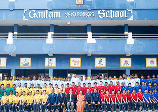 Students and staff in front of the school